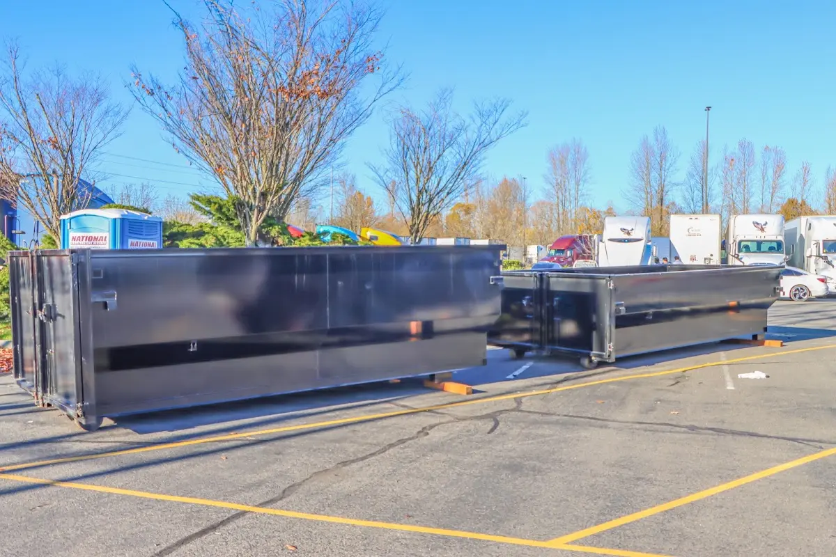 Professional dumpster rental service with roll-off container on residential driveway in Highgrove